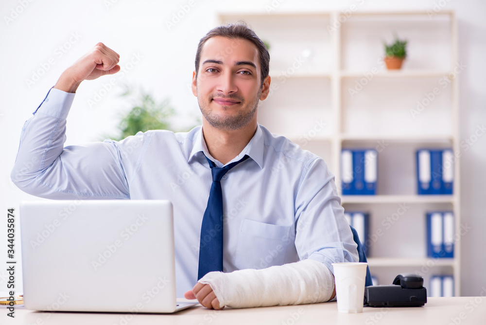 Injured male employee at workplace after accident Injured male employee at workplace after accident
