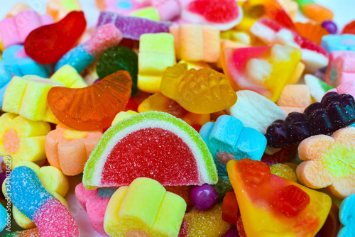 Many colorful lollipops with a sweet flavor placed on the plate.