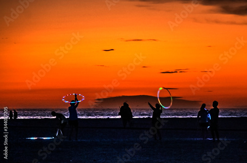  people with hula hoops on the beach, sunset, clouds, orange, red, Siesta Key, Florida