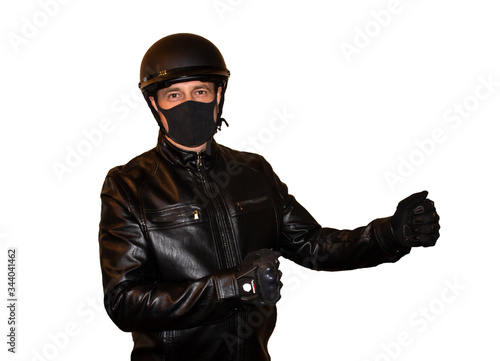 Isolated on white background man motorcyclist in a helmet and a mask that protects against coronavirus. Black jacket, protection and biker gloves © Liubov