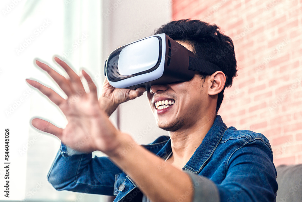 Man wearing virtual reality glasses enjoying game or 3D movies