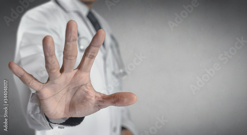 Medicine doctor or pharmacist show a stop hand.