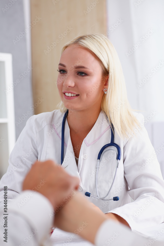 Young couple hold arms together in family doctor office closeup. Motherhood and child delivery IVF new life abortion therapeutist reception service physical hope emotion hospital expectation Young couple hold arms together in family doctor office closeup. Motherhood and child delivery IVF new life abortion therapeutist reception service physical hope emotion hospital expectation