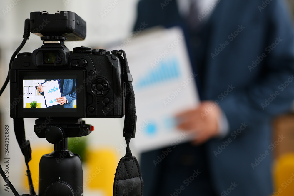 Male in suit and tie show stats graph pad making promo videoblog or photo session in office camcorder to tripod closeup. Vlogger selfie sale solution or finance advisor management information Male in suit and tie show stats graph pad making promo videoblog or photo session in office camcorder to tripod closeup. Vlogger selfie sale solution or finance advisor management information