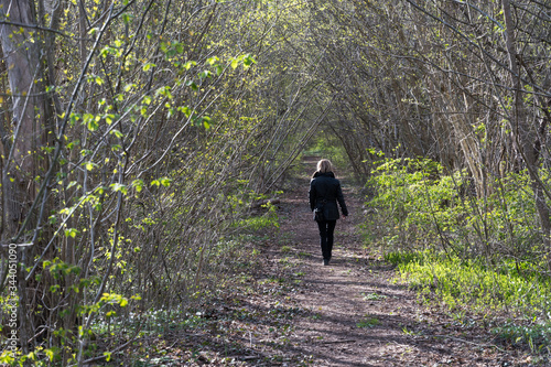 Woman walking alone in a forest