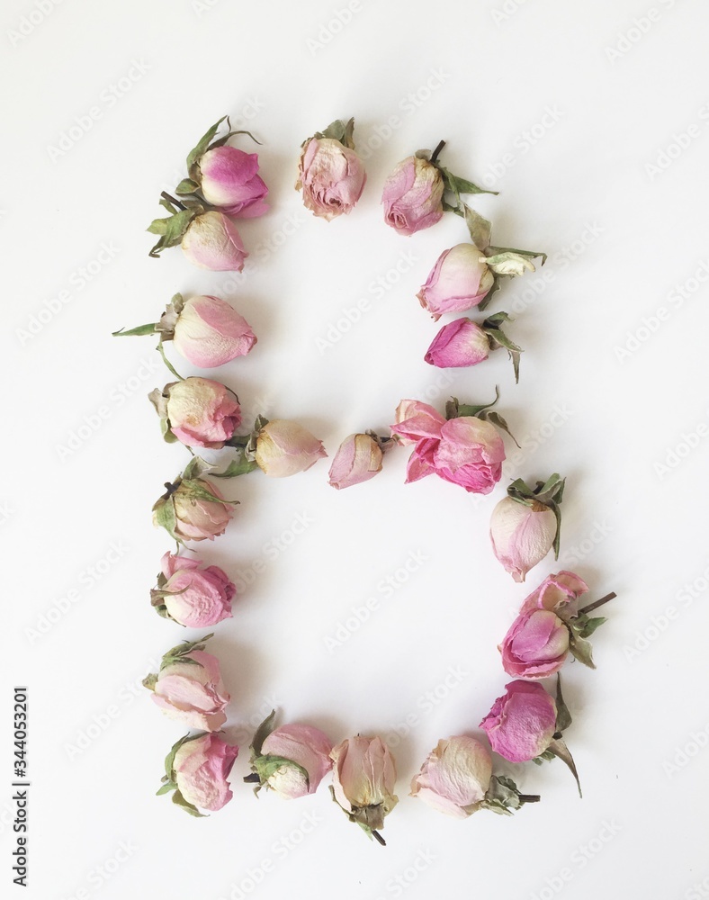 The letter B is made up of small pink roses on a white background The letter B is made up of small pink roses on a white background