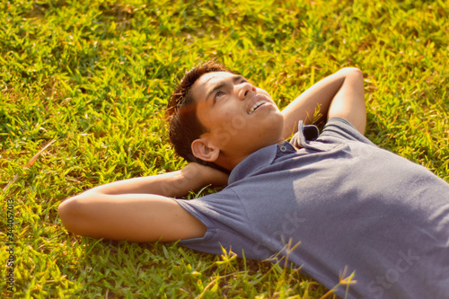 happy young woman lying on the grass