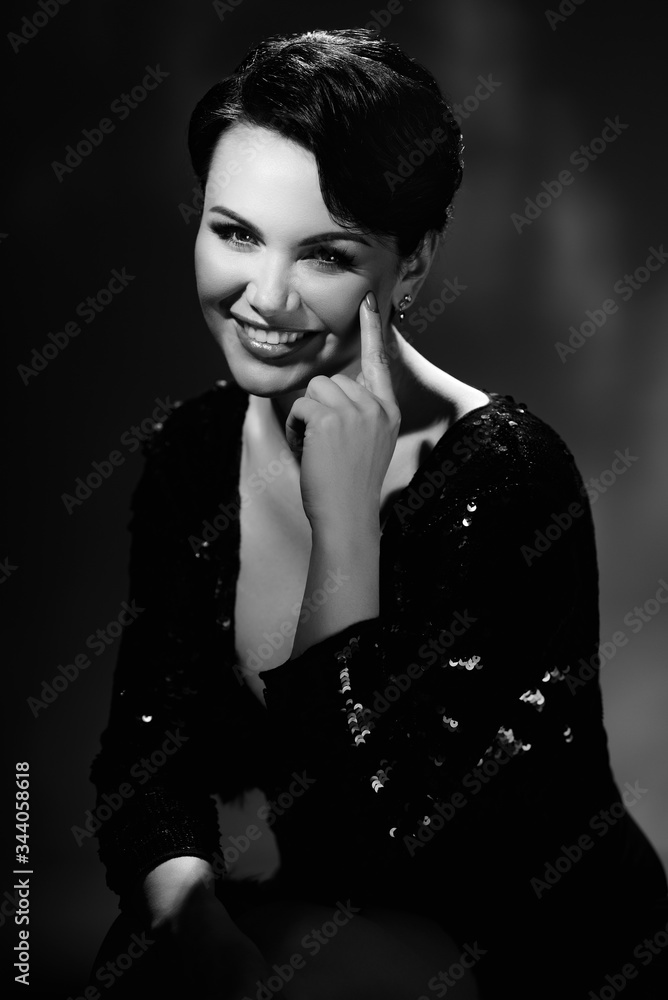 Black and white portrait of happy young brunette with perfect evening make-up