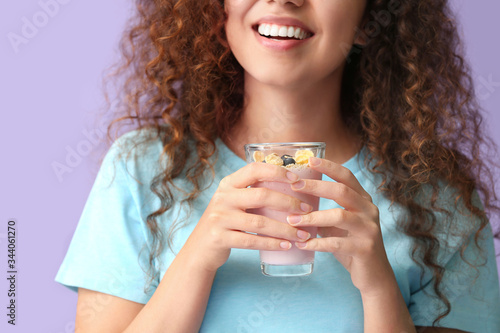 Young woman with tasty yogu...