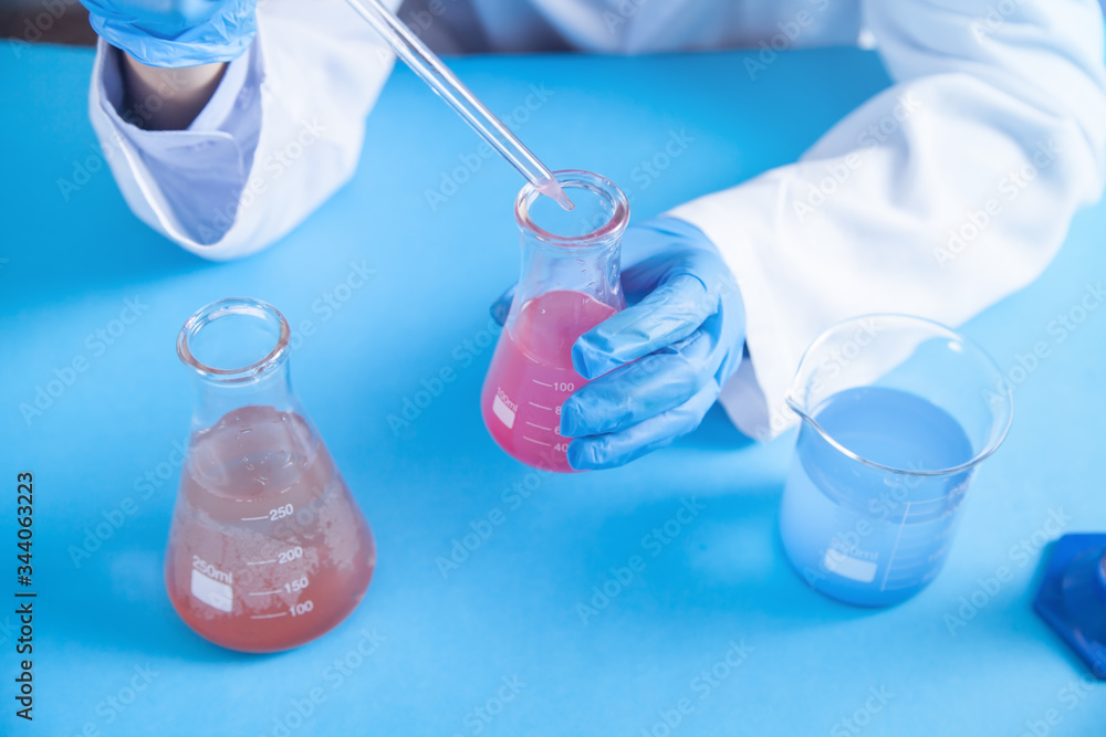 Girl working with flask in a laboratory. Girl working with flask in a laboratory.