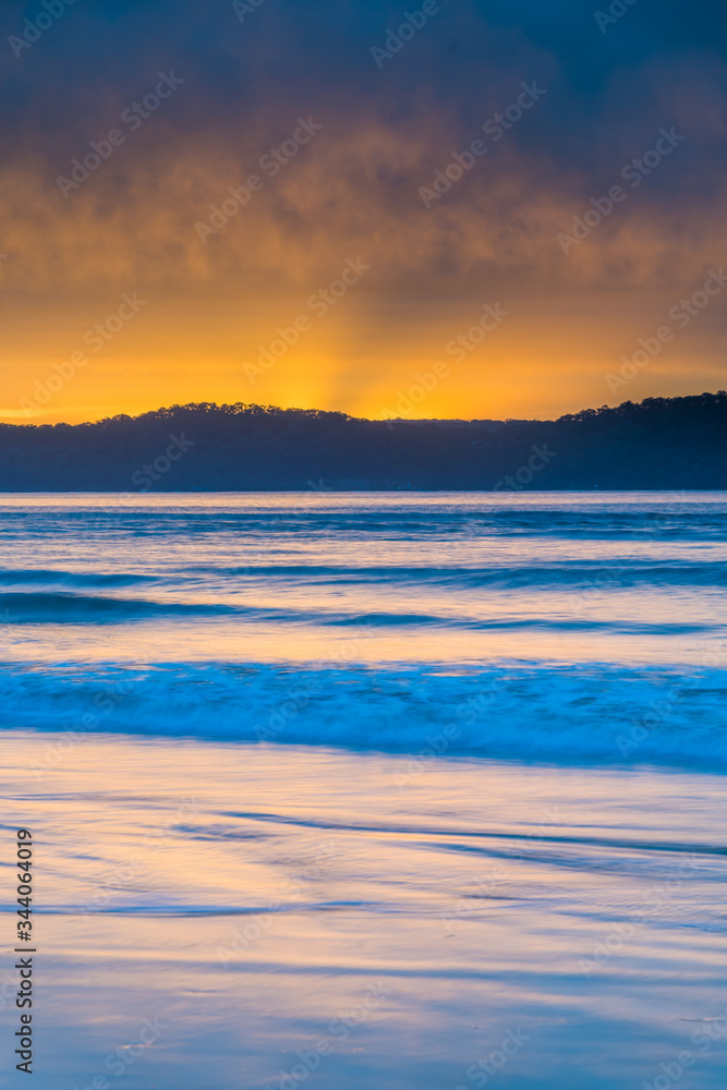 Fototapeta premium Cloud Covered Sunrise Seascape with Sun Rays