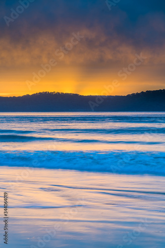 Cloud Covered Sunrise Seascape with Sun Rays © Merrillie