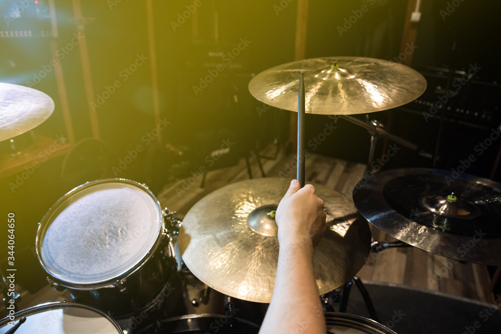 Obraz premium Professional drum set closeup. Man drummer with drumsticks playing drums and cymbals, on the live music rock concert or in recording studio 