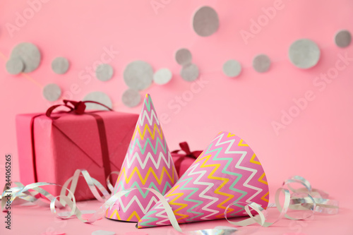 Party hats  gift and decor on color background