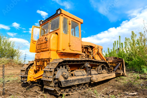 Industrial building construction site bulldozer leveling and moving soil during highway building