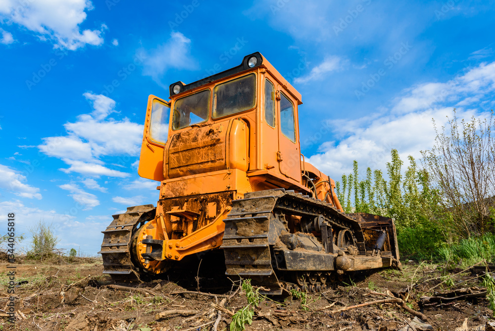 Industrial building construction site bulldozer leveling and moving soil during highway building Industrial building construction site bulldozer leveling and moving soil during highway building