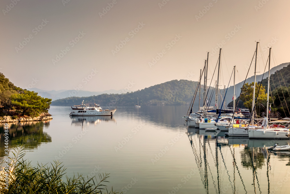Boats reflected in the still waters of Kapi Kreek, Gocek, Turkey at sunrise