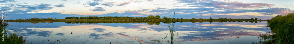 Panorama Evening or sunrise on a quiet forest lake in summer Panorama Evening or sunrise on a quiet forest lake in summer
