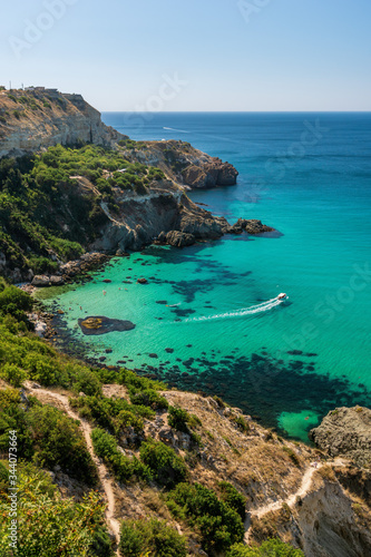 yachts on Baunty beach, cape Fiolent in Balaklava, Sevastopol, Russia. View from the top of the rock. azure sea, sunny day clear sky background. The concept of perfect place for summer travel and rest photo