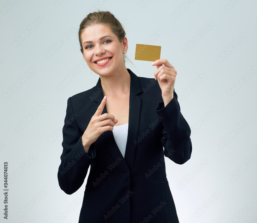 woman in black business suit holding credit card and pointing with finger. woman in black business suit holding credit card and pointing with finger.