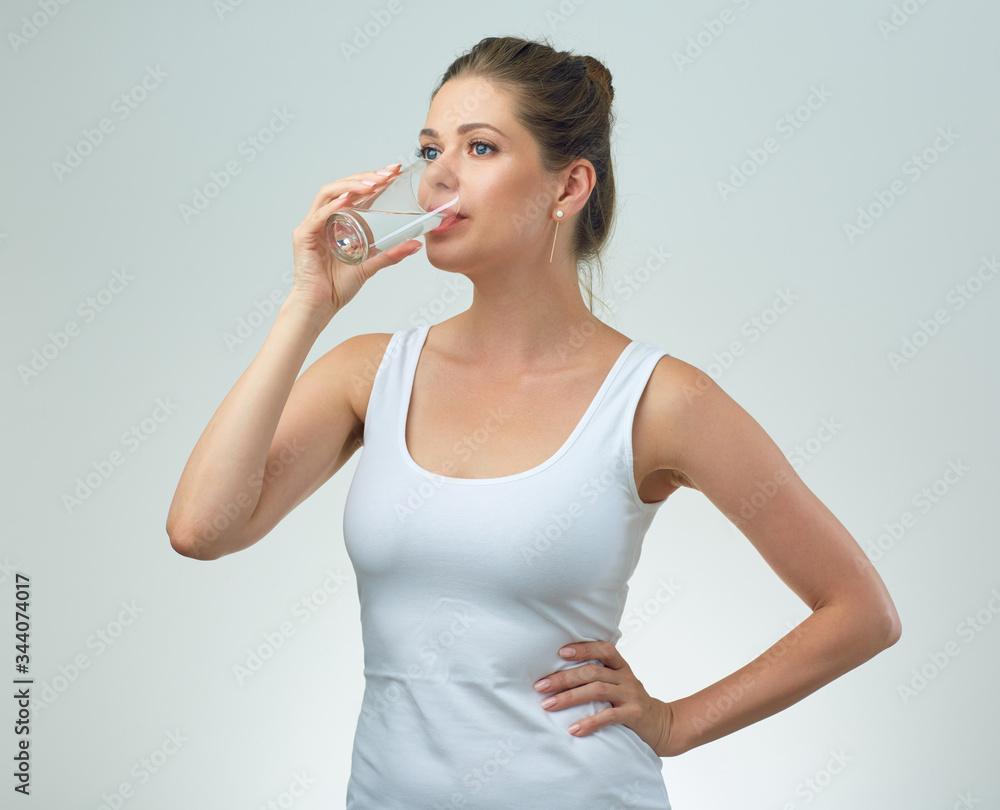 Sporty woman drinking water from glass. Sporty woman drinking water from glass.