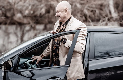 Older man in elegant jacket in car, senior men lifestyle 