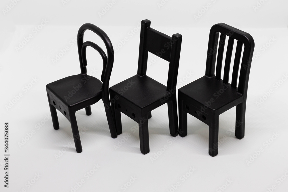 Obraz premium Mini toy chairs isolated on white background. Chair design, modern style