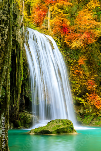 Fototapeta Naklejka Na Ścianę i Meble -  Colorful majestic waterfall in national park forest during autumn