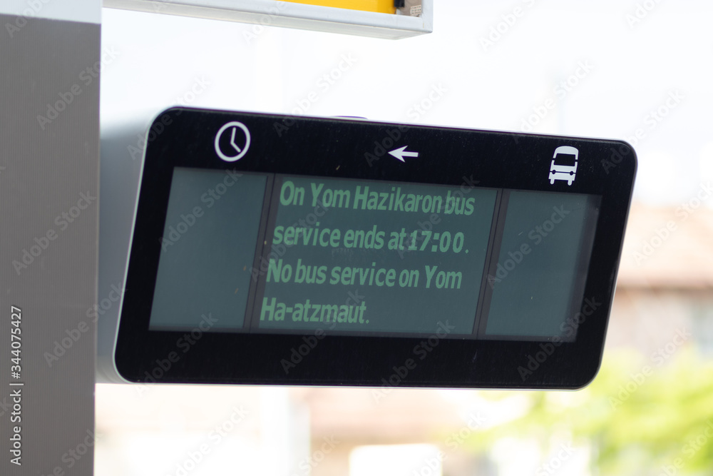 An electronic sign that updates public transit times. Changing transportation times on Memorial Day and Independence Day because of the Corona curfew An electronic sign that updates public transit times. Changing transportation times on Memorial Day and Independence Day because of the Corona curfew