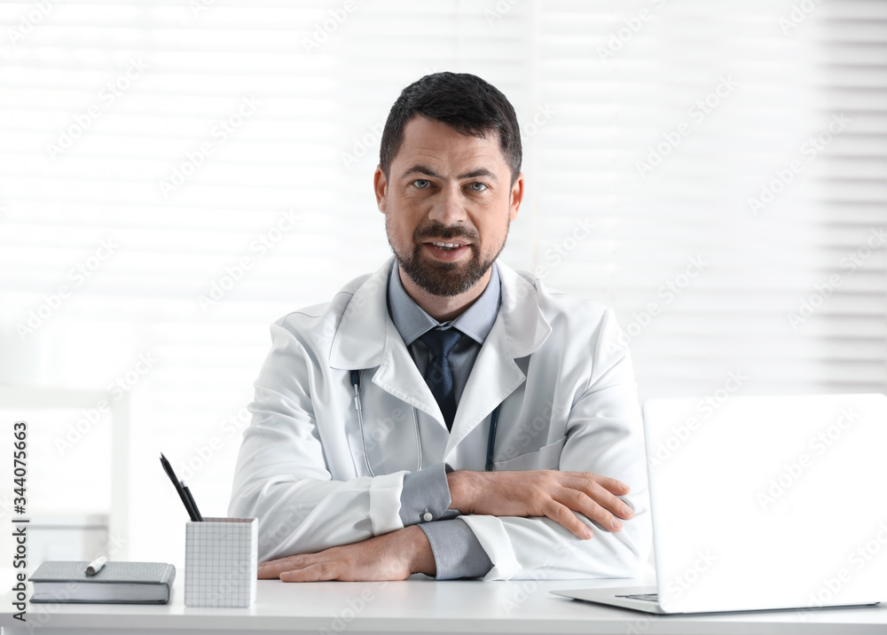 Portrait of male doctor in white coat at workplace Portrait of male doctor in white coat at workplace