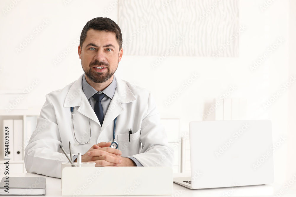 Portrait of male doctor in white coat at workplace Portrait of male doctor in white coat at workplace