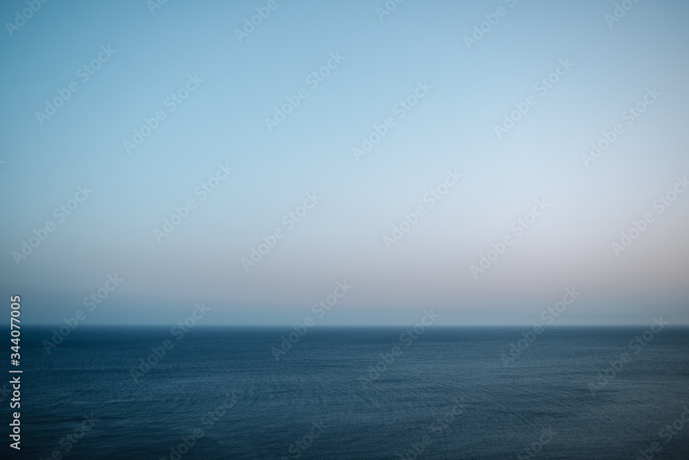 Maritime and minimalist view of the horizon with dark blue sea and large cloudless blue sky. Maritime and minimalist view of the horizon with dark blue sea and large cloudless blue sky.