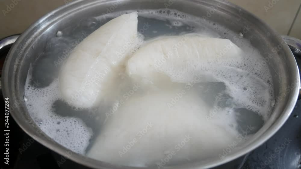 Nasi Impit or pressed rice in the plastic pack is boiled using hot water in a pan. Nasi Impit is usually cooked by Malay Muslims during Eid Celebration in Malaysia. Nasi Impit or pressed rice in the plastic pack is boiled using hot water in a pan. Nasi Impit is usually cooked by Malay Muslims during Eid Celebration in Malaysia.