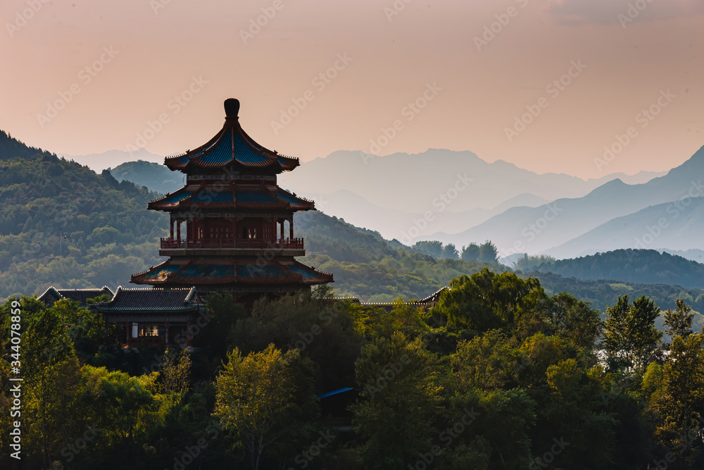 Fototapeta premium Chinese pagoda on an island, in the middle of water and mountains