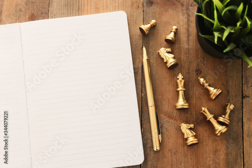 top view image of open notebook with blank pages on wooden table. ready for adding text or mockup