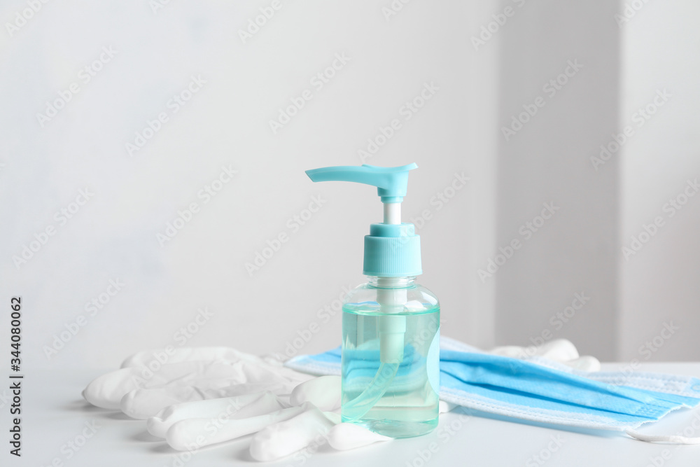 Antiseptic gel, protective gloves and mask on table indoors. Protection from virus Antiseptic gel, protective gloves and mask on table indoors. Protection from virus