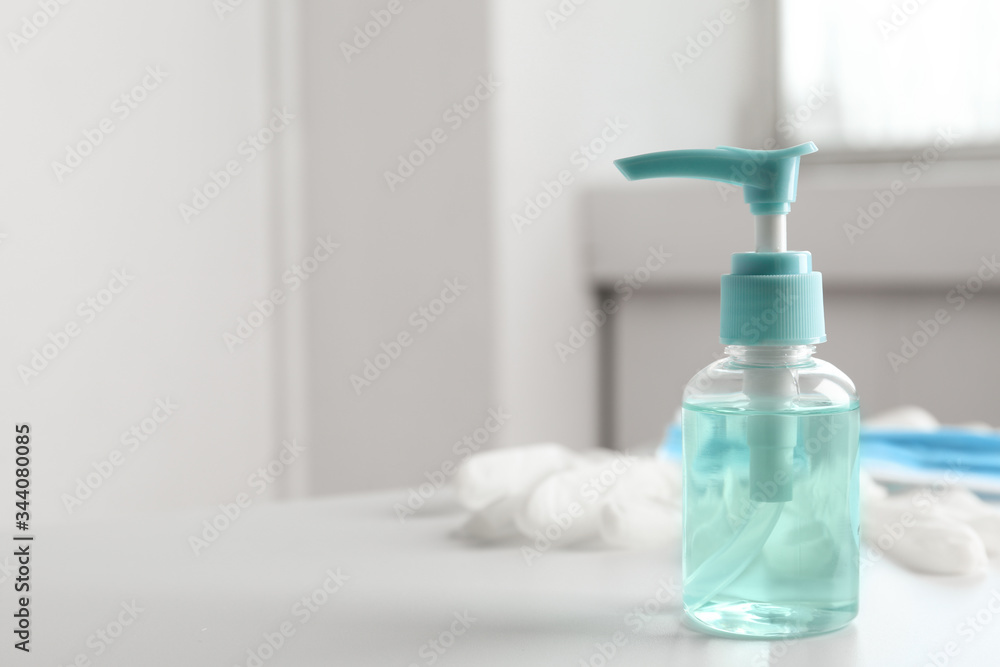 Antiseptic gel, protective gloves and mask on table indoors, space for text. Protection from virus Antiseptic gel, protective gloves and mask on table indoors, space for text. Protection from virus