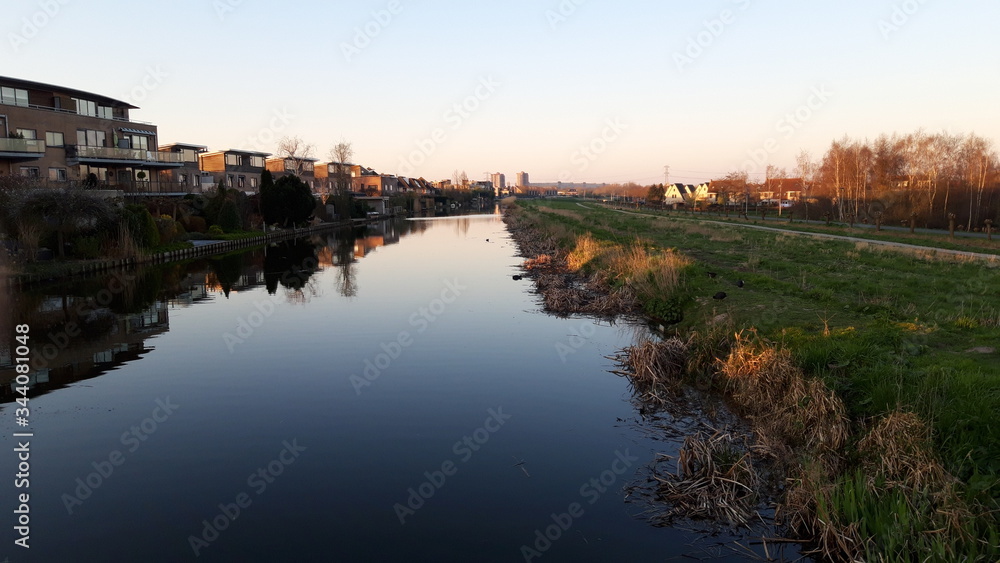 The sun rises over the ring canal of the Zuidplaspolder in the town of Nieuwerkerk aan den IJssel in the Netherlands