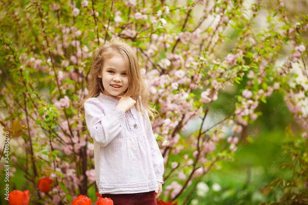 funny girl near with almond bush and tulips funny girl near with almond bush and tulips