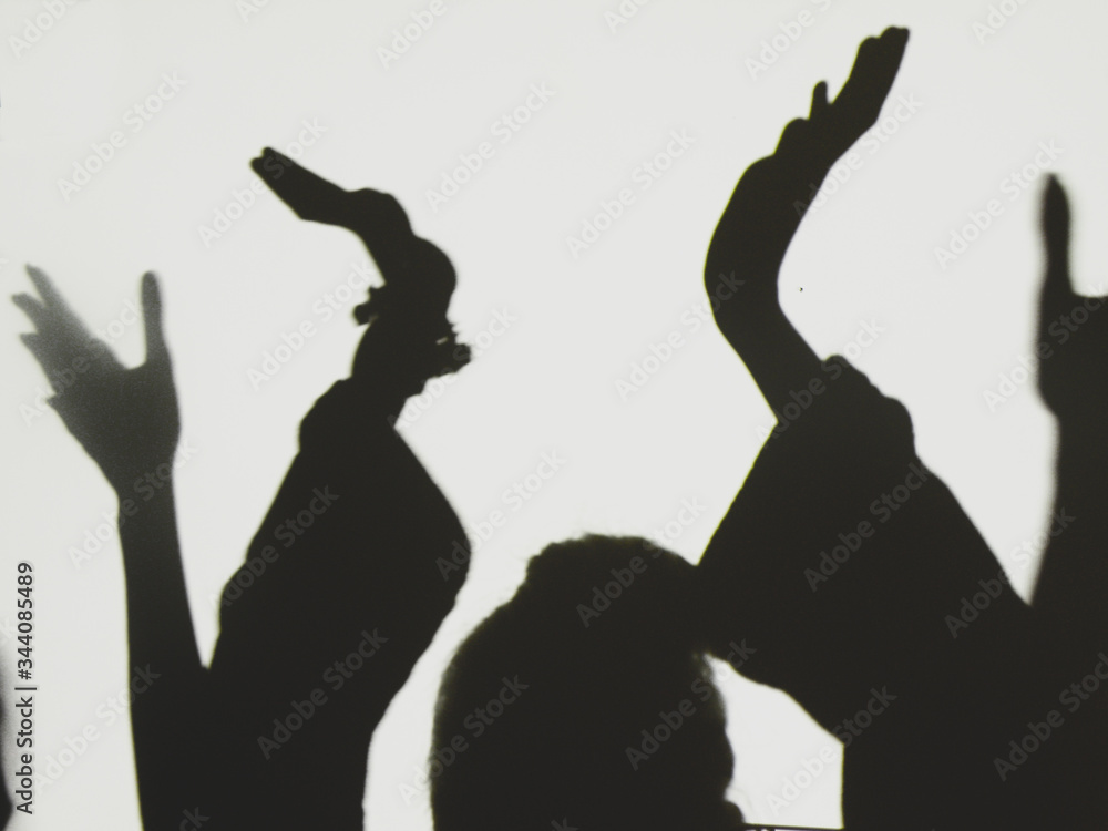Photo of shadows of young  woman,  close-up of hands
