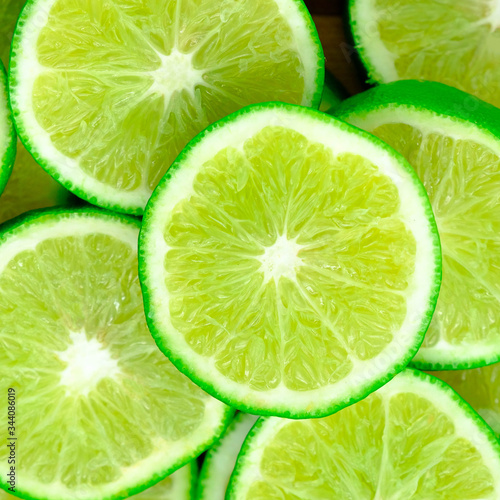 Green background with citrus-fruit of lime slices, Lemon texture
