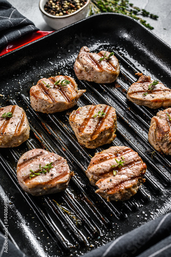 Tender boneless grilled pork chops. steak tenderloin. gray background. Top view