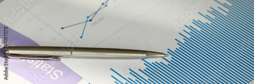 Fotografía Close-up of analysis graphics on table with silver pen