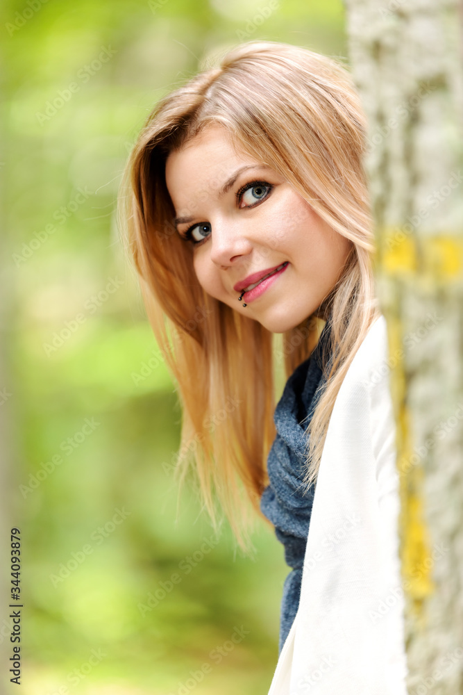 young woman standing in the green forest young woman standing in the green forest
