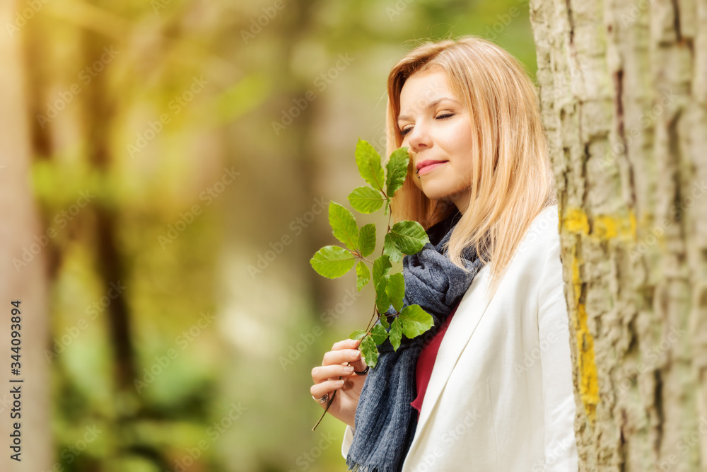 young woman standing in the green forest young woman standing in the green forest