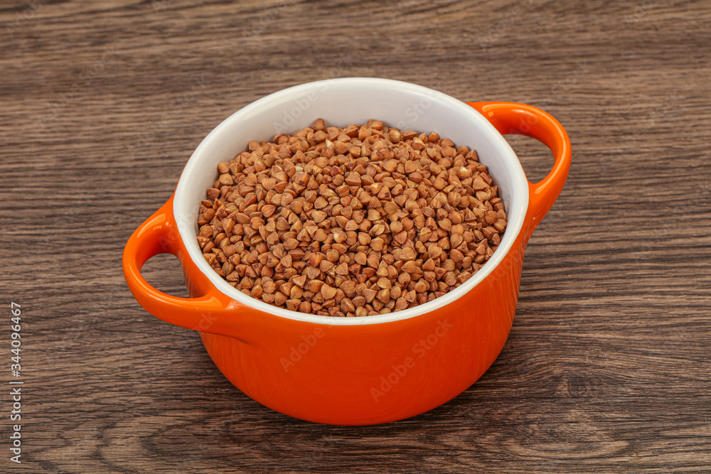 Raw buсkwheat cereal in the bowl Raw buсkwheat cereal in the bowl