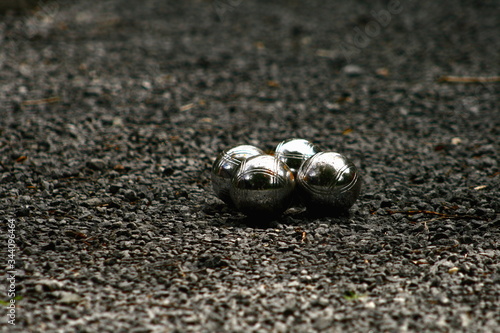 petangue or boules metal balls on gravel in the backyard garden