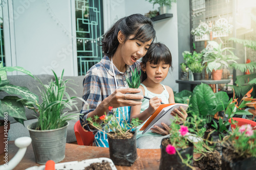 mother and daughter gardening and studying activity at home together