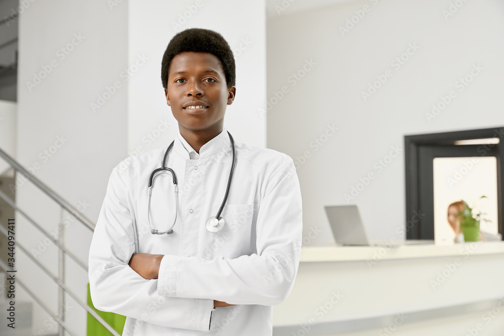 Smiling african doctor in coat with arms crossed. Smiling african doctor in coat with arms crossed.