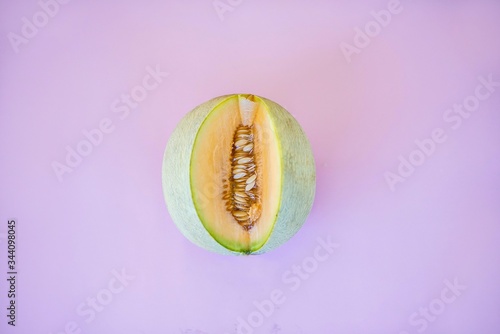 A melon cut open with seeds showing.